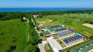 an aerial view of a building with the ocean in the background at Domki Gala- blisko plaży, basen z podgrzewaną wodą , sauna , parking in Grzybowo