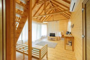 a large room with wooden walls and a wooden ceiling at Zaga Zaga Sat in Tecuci