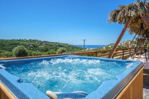 a jacuzzi tub with a view of the ocean at Fisi & Wellness Exclusive Villa with Spa Vibes in Stavromenos