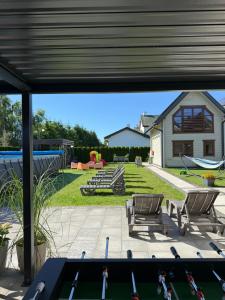 a view through a window of a backyard with a pool at Domki Gala- blisko plaży, basen z podgrzewaną wodą , sauna , parking in Grzybowo +90 photos