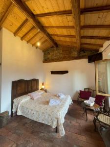 a bedroom with a large bed and a wooden ceiling at Antica Calvasino in Lezzeno