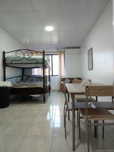 a room with two bunk beds and a table at MiniSuite in Machala