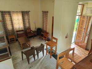 an overhead view of a living room with chairs and tables at MP Residency Homestay in Munsyari