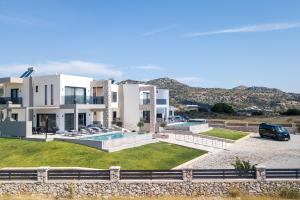 a villa with a car parked in a parking lot at Blue Sunrise Villa 2 in Afantou