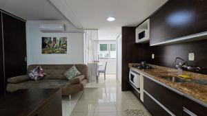 a living room with a couch in a kitchen at Baviera Studio Canela in Canela