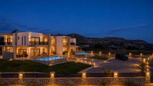 a large house with lights in front of it at night at Blue Sunrise Villa 1 in Afantou