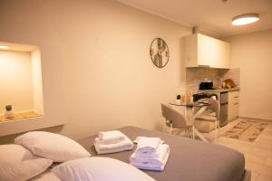 a room with a bed and a small kitchen at Kallia Castle apartments in Chios +40 photos