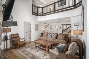 a living room with a couch and a table at Flat Top Lodge in Blowing Rock