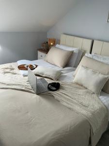 a bedroom with two beds with a laptop on it at Chamberlain House in Derry Londonderry +68 photos