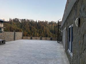 a large patio with a view of a mountain at Landmark Hotel & Resort in Taiwāl