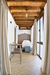 a bedroom with a bed and a table and chairs at Villa Osmani in Shkodër