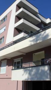 a building with a balcony in front of it at Apartman Lejla in Bjelašnica