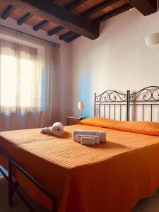 a bedroom with a bed with two towels on it at Affittacamere La Mattonata in Città di Castello