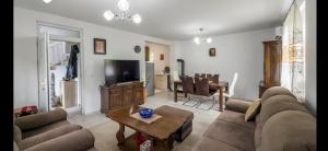 a living room with a couch and a table at Vila-kuca"Jasmin"pored rijeke i jezera in Konjic