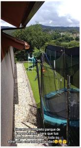 a batting cage in a backyard with a playground at Eido da Consaca in Ponteareas
