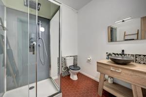 a bathroom with a glass shower and a toilet at lemasrocamour in Roquemaure +5 photos