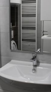 a bathroom with a white sink and a mirror at Apartman Lejla in Bjelašnica +18 photos