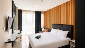 a hotel room with a bed and a television at SleepRest @ NTC in Nagoya