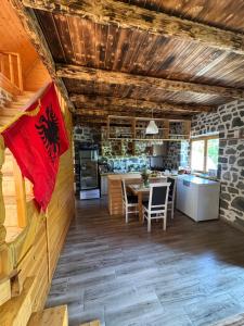 a kitchen and dining room with a flag at Nini Guesthouse Theth in Theth