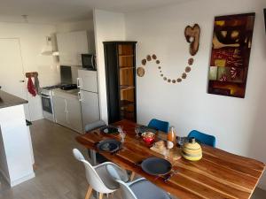 a dining room with a wooden table and chairs at L'escale marine in Pléneuf-Val-André +31 photos