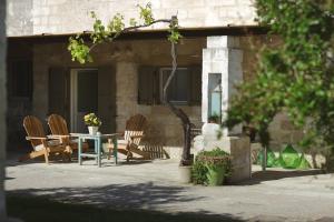 a table and chairs sitting outside of a building at Masseria Borgo Sentinella in Torre dell'Orso