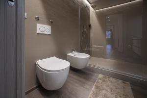 a bathroom with a toilet and a sink and a shower at Angels Home 3-AffittiPontediLegno in Ponte di Legno