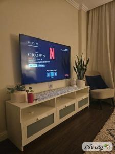 a flat screen tv sitting on top of a dresser at Life city home in 6th Of October