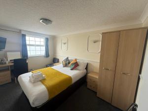 a hotel room with a bed and a desk at The President Hotel in Blackpool +116 photos