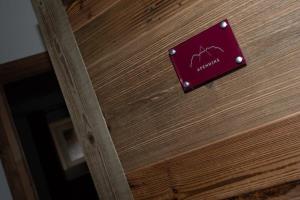 a wooden door with a sign on it at APPENNINS Annecy Rent Lodge in Annecy