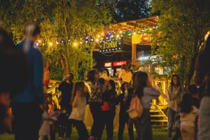 a crowd of people walking in a park at night at Zaga Zaga Sat in Tecuci +144 photos