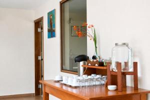 a table with cups and a mirror in a room at Hotel Sol Natura in Ollantaytambo +69 photos