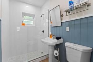 a bathroom with a sink and a toilet and a mirror at Sailors Knot in Cocoa Beach