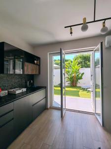 a kitchen with an open door to a yard at Villa Baia dei Gruccioni in Trani
