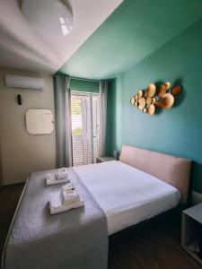 a bedroom with a large bed with a blue wall at Villa Baia dei Gruccioni in Trani