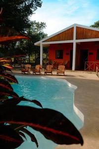 a swimming pool in front of a building at Cabañas Chechén Chaká in Leona Vicario