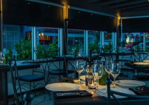 a restaurant with tables and chairs with wine glasses at Casa Condado Hotel & Residences in San Juan
