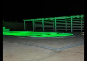 a skate park with green lights in a parking lot at Mavana Cottages in Ol Pejeta Conservancy