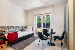 a bedroom with a bed and a table and chairs at Lakeside Retreat Apartment in Bestensee