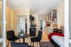 a bedroom with a bed and a table and chairs at Lakeside Retreat Apartment in Bestensee