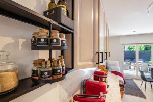a kitchen with a counter with jars of spices at Lakeside Retreat Apartment in Bestensee +13 photos