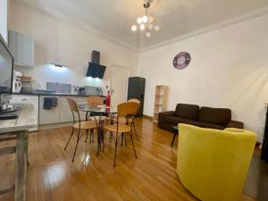 a living room with a couch and a table and chairs at Le Payan in Gap +10 photos