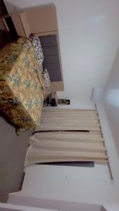 a bed in a small room with avertisementatronatronatronstrationstration at Maison d'hôtes Jaxaay in Keur Massar +9 photos