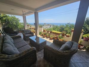 a patio with couches and chairs on a balcony at Vesna Apartments in Ulcinj