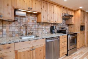 a kitchen with wooden cabinets and stainless steel appliances at Krystal Villa #5 in Ketchum