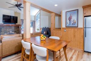 a kitchen and dining room with a wooden table and chairs at Krystal Villa #5 in Ketchum