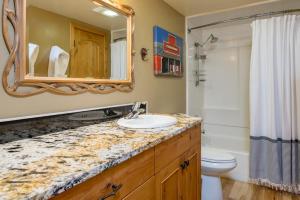 a bathroom with a sink and a mirror and a toilet at Krystal Villa #5 in Ketchum +6 photos