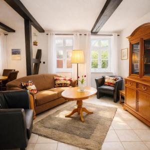 a living room with a couch and a table at Fachwerkhaus Bodenwerder in Bodenwerder