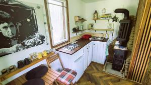 a kitchen with a counter and a window in it at Retreat în padure in Buchin +20 photos