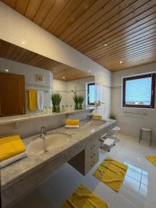 a large bathroom with a sink and a mirror at Frühstückspension-Appartementhaus Wasserer in Bad Kleinkirchheim +105 photos