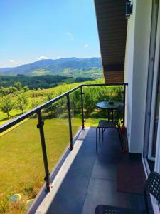 a balcony with a table and a view of the mountains at Gorczańska EKO-SFERA in Wola Piskulina